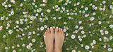Person walking barefoot on grass demonstrating grounding/earthing practice