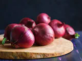 A vibrant close-up of a sliced red onion, showcasing its rich color and layers, symbolizing health benefits.